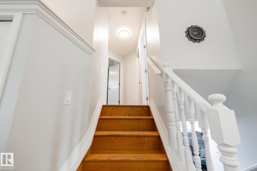 Hardwood stairs with white painted balusters and newel posts - 27 Danforth Crescent, St. Albert, AB 