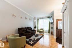 Open-concept living area with wood-finish flooring - 