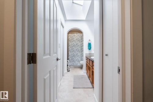 Hallway with a skylight and light-toned flooring - 27 Danforth Crescent, St. Albert, AB 