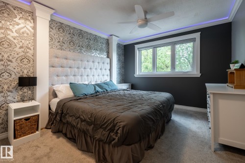 Accent wall with patterned wallpaper and a tufted upholstered headboard - 27 Danforth Crescent, St. Albert, AB 