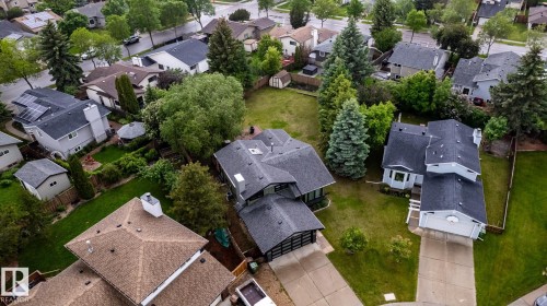 Single-family residence featuring a dark shingle roof, attached garage, and light-toned siding - 27 Danforth Crescent, St. Albert, AB 