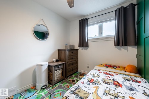 White painted walls featuring a window with a white frame and dark curtains - 27 Danforth Crescent, St. Albert, AB 