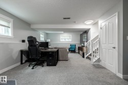 Finished lower level with soft gray carpeting and light gray walls - 