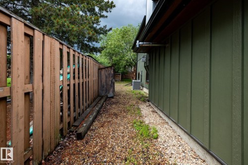 Side yard featuring gravel ground cover and board and batten siding - 27 Danforth Crescent, St. Albert, AB 