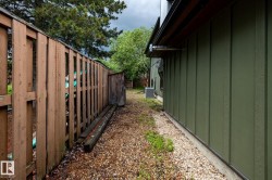 Side yard featuring gravel ground cover and board and batten siding - 