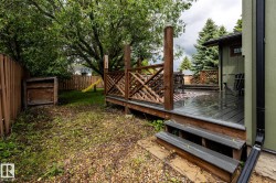 Expansive outdoor deck with wood-finish decking and decorative lattice railing - 