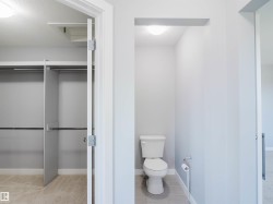 Private water closet with a floor-mounted toilet and tiled flooring - 