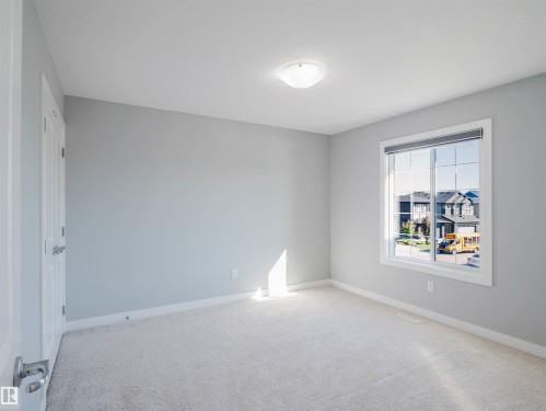 Interior room featuring light gray walls and plush carpeting - 2526 Wonnacott Loop, Edmonton, AB 