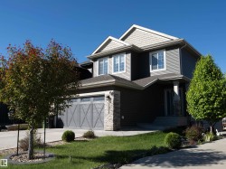 Contemporary two-story residence featuring horizontal siding and decorative shake accents - 