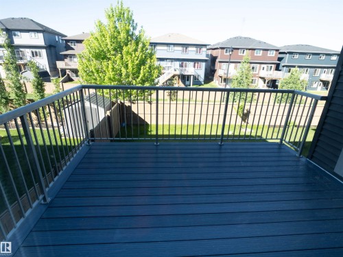Private balcony featuring composite decking, metal railings, and siding - 2526 Wonnacott Loop, Edmonton, AB 