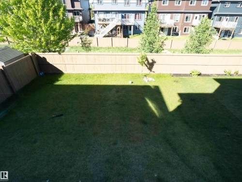 Expansive grassed backyard framed by wood privacy fencing - 2526 Wonnacott Loop, Edmonton, AB 