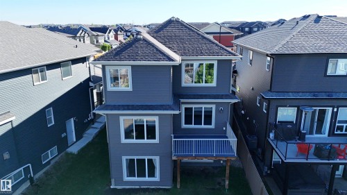 Gray siding exterior with multiple windows - 2526 Wonnacott Loop, Edmonton, AB 