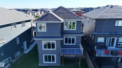 Gray siding exterior with multiple windows - 