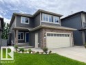 Two-story residence featuring dark gray siding and stone veneer accents - 805 Hodgins Road, Edmonton, AB 