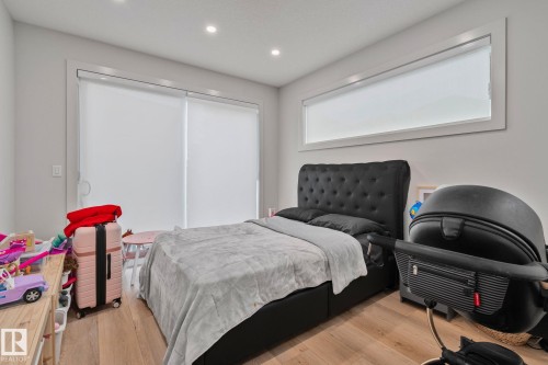 Room featuring wood-finish flooring, recessed lighting, and a horizontal window with white trim - 4509 Wingfield Bay Bay, Edmonton, AB 