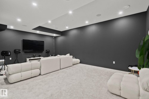 Media room featuring dark gray walls, recessed ceiling lighting, a dropped ceiling detail, and light-toned carpeting - 4509 Wingfield Bay Bay, Edmonton, AB 