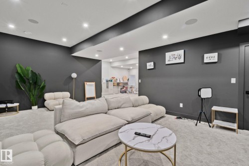 Spacious room featuring dark accent walls and light gray carpeting - 4509 Wingfield Bay Bay, Edmonton, AB 