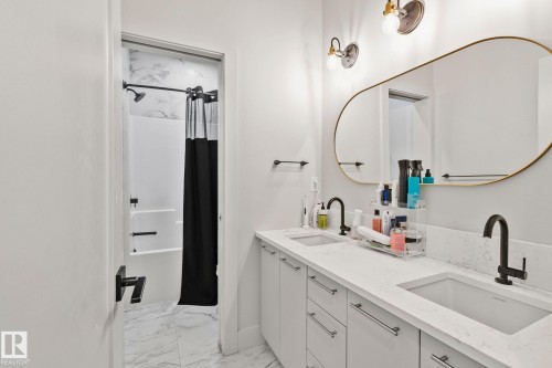 Dual vanity featuring integrated sinks and white countertops - 4509 Wingfield Bay Bay, Edmonton, AB 