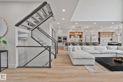 Open concept living space featuring wood-finish flooring and recessed lighting - 4509 Wingfield Bay Bay, Edmonton, AB 