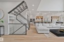Open concept living space featuring wood-finish flooring and recessed lighting - 4509 Wingfield Bay Bay, Edmonton, AB 