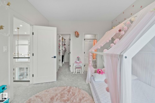 Carpeted room with a walk-in closet featuring built-in shelving - 4509 Wingfield Bay Bay, Edmonton, AB 