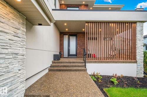 Contemporary exterior featuring a split-level entryway with exposed aggregate steps and walkway - 4509 Wingfield Bay Bay, Edmonton, AB 