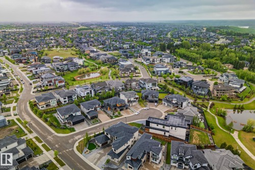 Aerial perspective of a developed residential area featuring a variety of architectural styles, paved roadways, and integrated green spaces - 4509 Wingfield Bay Bay, Edmonton, AB 