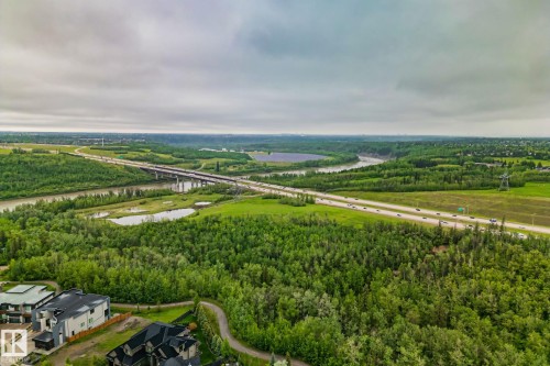 Expansive aerial landscape featuring a river, verdant forests, and a multi-lane highway with an overpass - 4509 Wingfield Bay Bay, Edmonton, AB 