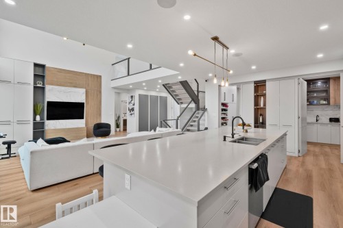 Expansive kitchen island with an undermount sink and matte black faucet - 4509 Wingfield Bay Bay, Edmonton, AB 