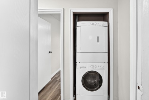 Dedicated laundry area featuring a stacked washer and dryer unit - 1103 56 Street, Edmonton, AB 