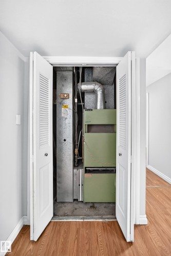 Utility closet with bi-fold louvered doors, housing a central HVAC system and ductwork - 1103 56 Street, Edmonton, AB 