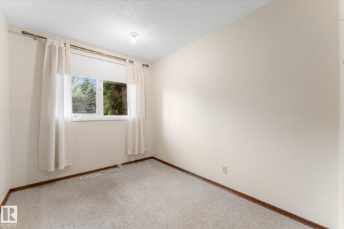 Neutral-toned walls complement the light-colored carpeting - 15112 76A Avenue, Edmonton, AB 