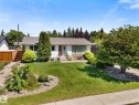 White siding residence with a brown shingle roof, featuring a concrete walkway to the front entrance - 15112 76A Avenue, Edmonton, AB 