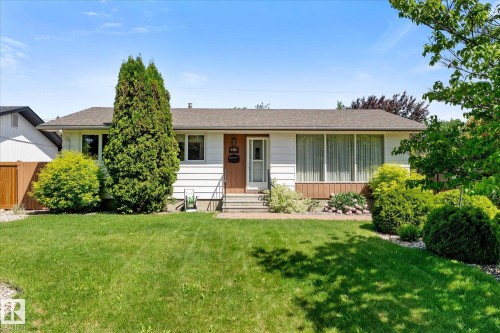 Single-story residence featuring white horizontal siding and a dark shingle roof - 15112 76A Avenue, Edmonton, AB 