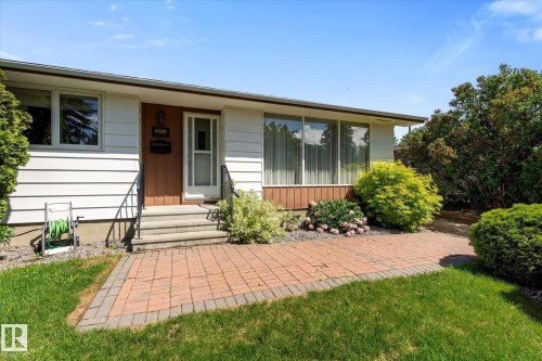 Ranch-style exterior with white siding and brown accent panels - 15112 76A Avenue, Edmonton, AB 