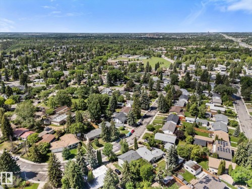 Mature treed neighborhood with a mix of residential properties, paved streets, and a prominent green space - 15112 76A Avenue, Edmonton, AB 