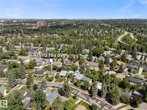 Aerial perspective showcasing a residential area with varied housing styles and mature tree landscaping - 15112 76A Avenue, Edmonton, AB 