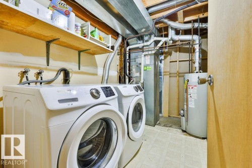 Laundry area featuring wood-finish shelving and durable flooring - 17009 109 Street, Edmonton, AB 