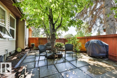 Rear patio featuring a combination of square pavers and brick-patterned hardscaping - 17009 109 Street, Edmonton, AB 