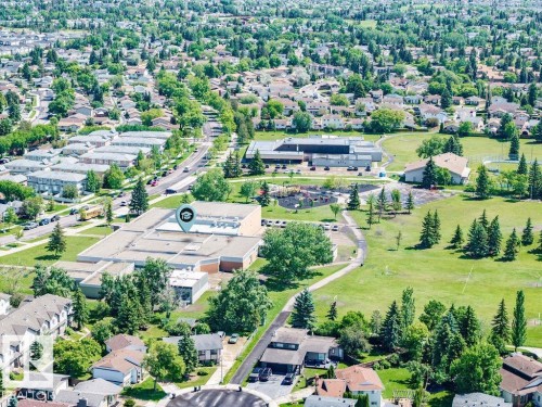 Expansive aerial perspective showcasing a residential area with extensive green spaces and mature trees - 17009 109 Street, Edmonton, AB 