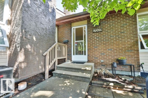 Front entryway with concrete steps and a white storm door - 17009 109 Street, Edmonton, AB 