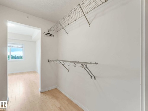 Walk-in closet featuring wire shelving and hanging rods - 406 9519 160 Avenue, Edmonton, AB 