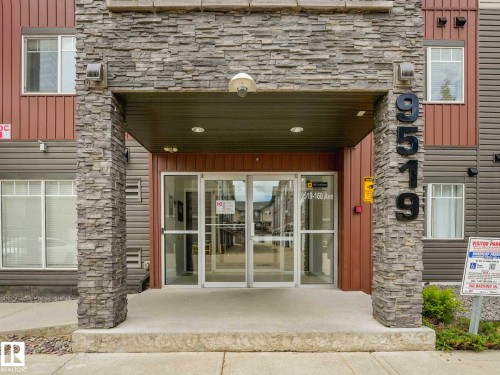 Building exterior featuring a stone facade and siding accents - 406 9519 160 Avenue, Edmonton, AB 