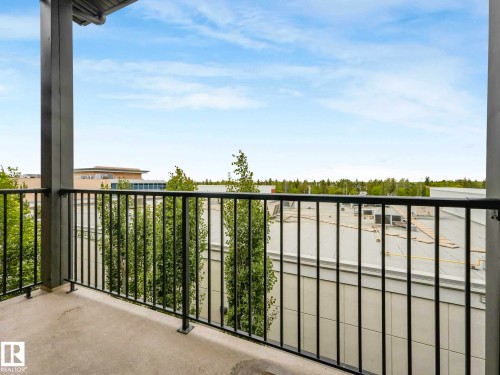 Outdoor balcony with concrete flooring, protected by a dark metal railing - 406 9519 160 Avenue, Edmonton, AB 