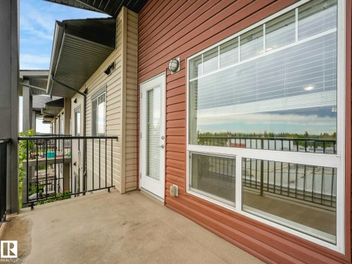 Private concrete balcony featuring a metal railing system - 406 9519 160 Avenue, Edmonton, AB 