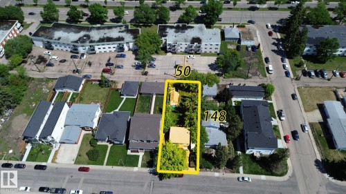 Aerial perspective of a long rectangular property featuring two structures and mature trees - 9209 150 Street, Edmonton, AB 