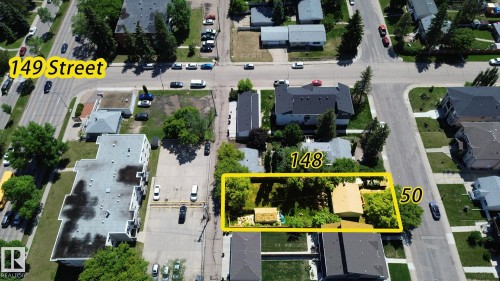 Aerial view of a residential property with a single-story structure, ample green space, and mature trees - 9209 150 Street, Edmonton, AB 