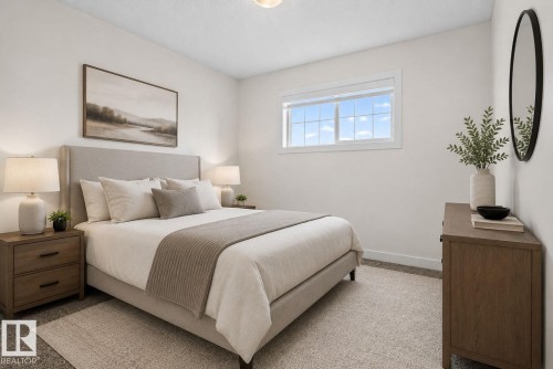 Bright bedroom with a large window and neutral wall tones - 5306 67 Street E, Beaumont, AB 