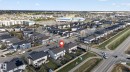 Aerial perspective showcasing a residential development with varied housing styles - 5306 67 Street E, Beaumont, AB 