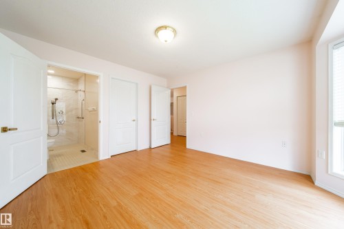 Bright room featuring wood-finish flooring, light-toned walls, and a ceiling-mounted light fixture - 120 13320 124 Street Nw, Edmonton, AB 